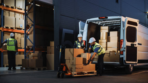 Delivery van being loaded with boxes at a warehouse loading bay
